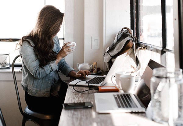 Woman working on computer managing massage business